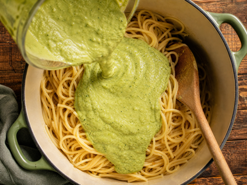 Blend the sauce. While the pasta cooks, add the avocado, spinach, garlic, nuts, olive oil, lemon juice, and Parmesan to a blender. Start with ¼ cup of the warm pasta water and blend until smooth, adding more a tablespoon at a time if it's too thick.